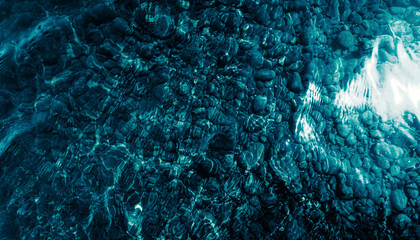 dark blue pebbly river floor