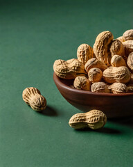 Peanuts photographed against a solid green background.