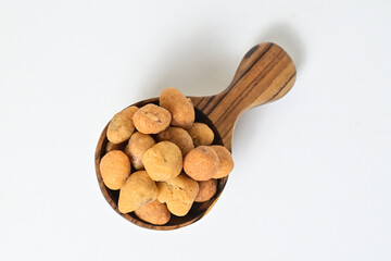 Top view of egg nuts in the little wooden spoon isolated on white background. Clipping path. Close up. High angle, above.