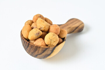 Photo of egg nuts in the little wooden spoon isolated on white background. Clipping path. Close up. 