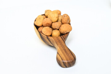 Photo of egg nuts in the little wooden spoon isolated on white background. Clipping path. Close up. 