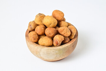 Close up view of egg nuts in the little wooden bowl isolated on white background. Clipping path.