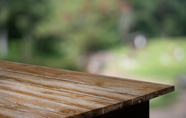 Empty wood table top and blur of restaurant background selective focus product display