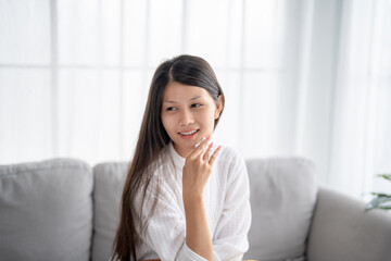 Daily beauty routine Asian woman.with clean skin uses micellar water to remove makeup