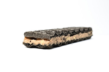 Photo of black waffle cookies and cream isolated on white background. Clipping path. Close up.