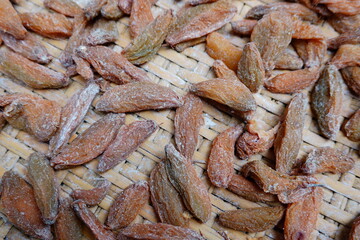 Close-Up of Dried Bilimbi Fruits Meticulously Arranged on a Rustic Woven Tray