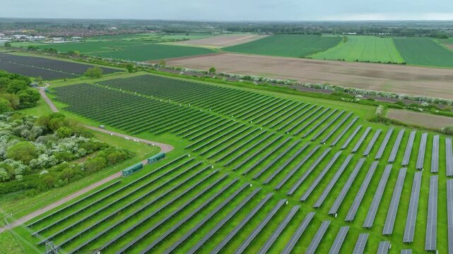 Aerial drone solar power station renewables gas coal fossil fuels Electricity generation Agri voltaic trainline railway closeup rural fields England UK