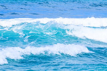 Beautiful sea waves with foam of blue and turquoise water color. Summer seascape. Travel concept and idea. 