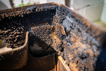 Carbon and resin inside the fireplace stove after the heating season. Cleaning the stove from...