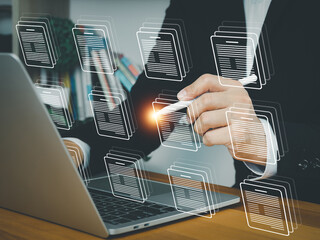Businessman digital document management on laptop with holographic interface. Sorting or managing files. Organizing digital organization data storage documents in online database.