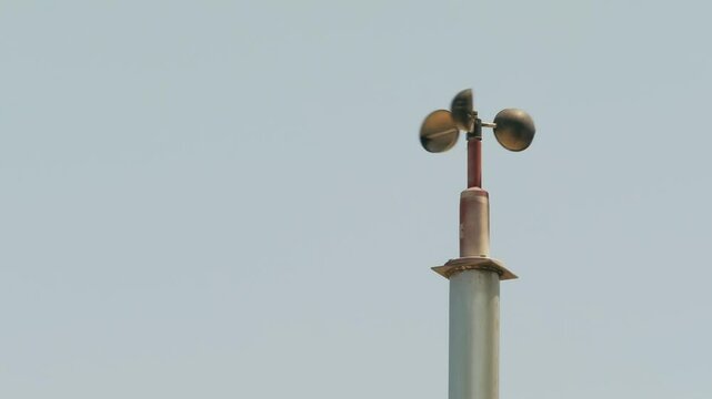 Tokyo, Japan - May 7, 2025: Revolving anemometer on blue sky background