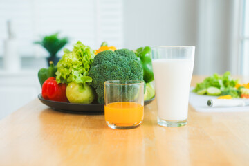 A fresh assortment of colorful vegetables, orange juice,milk highlights a balanced diet.The measuring tape symbolizes healthy eating,weight control,nutrition-focused lifestyle choices for wellness
