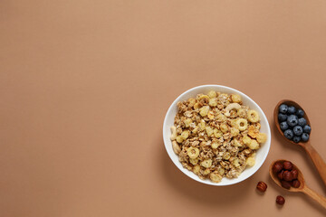 Muesli in a bowl on the table with fresh fruit
