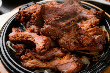Pork Back Ribs BBQ on a Black Grill Plate
