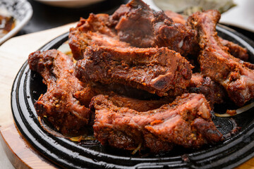 Pork Back Ribs BBQ on a Black Grill Plate
