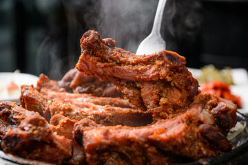 Pork Back Ribs BBQ on a Black Grill Plate
