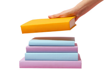 Hand places a yellow book atop a stack of colorful study materials, isolated on white, PNG
