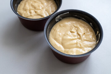 Raw dough in round baking pans. Homemade baking and confectionery from wheat flour. Making bread and Easter cakes