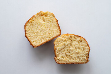 Muffin cut into two parts, top view. The muffin is golden brown and has a slightly crispy texture. Homemade baking and pastry made from wheat flour. Making bread and Easter cakes