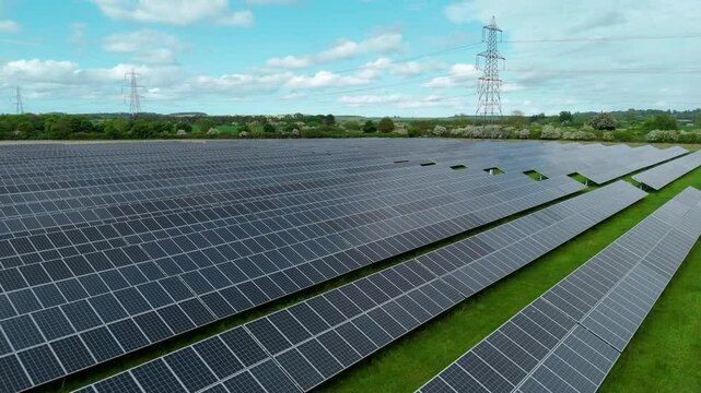 Aerial drone solar power station renewables gas coal fossil fuels Electricity generation Agri voltaic trainline railway closeup rural fields England UK