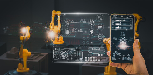 Automated industry engineer in smart digital factory controlling robotic machine arm with AI and machine learning via smart glass tablet using 5G network – automation and intelligent business tech