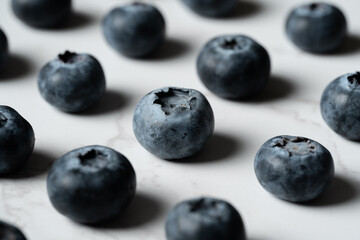 Blueberries Arranged on White Marble Background