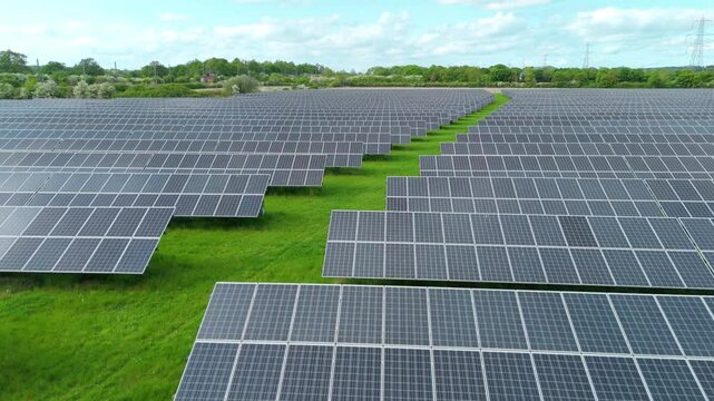 Aerial drone solar power station renewables gas coal fossil fuels Electricity generation Agri voltaic trainline railway closeup rural fields England UK