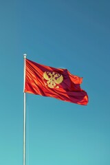 Montenegro independence day celebration with national flag against clear sky. Vertical banner. Copy space. Waving flag of Montenegro in the sky