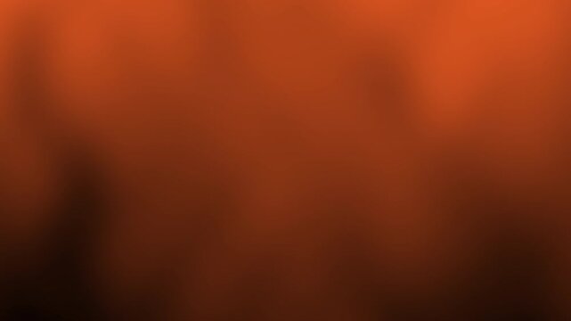 A soft, blurred orange and brown gradient background without any distinct objects or details.