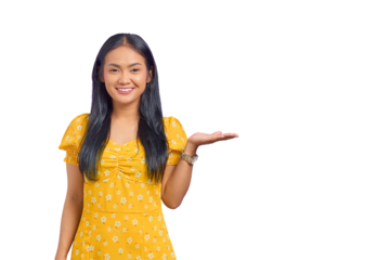 Portrait of smiling young Asian woman showing copy space on palm isolated on transparent background