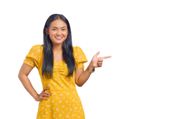 Portrait of smiling young Asian woman pointing finger at copy space isolated on transparent background