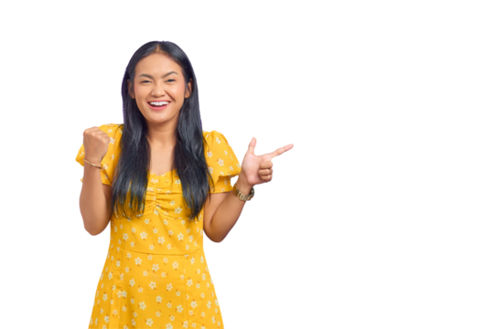 Portrait of smiling young Asian woman pointing finger at copy space isolated on transparent background