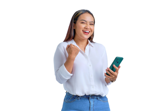 Excited young Asian woman using mobile phone gesturing yes with raised fist reacting to online news isolated on transparent background