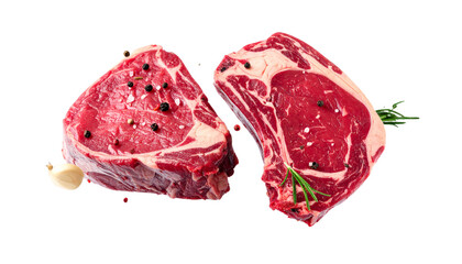 Obraz premium Fresh ribeye steak with marbling, garlic cloves, and herbs, showcasing vibrant red color and rich texture, perfect for grilling or cooking