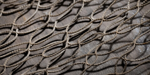 Fishing net on rustic old wood, fishing concept, art craft themes

