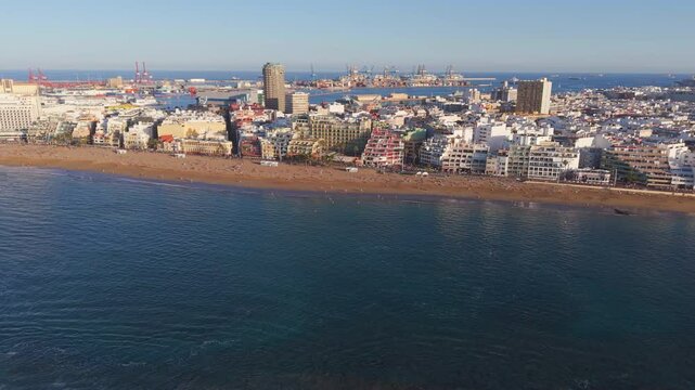 Panoramic aerial footage capturing vibrant sunset glowing over las canteras beach, revealing las palmas cityscape with golden evening light and coastal scenery in gran canaria