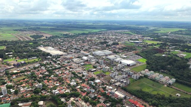 Expansive aerial view of residential Toledo city blocks with populated areas and distanced horizon, Paran&aacute;, Brazil.