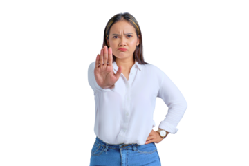 Serious young Asian woman showing stop gesture with angry expression isolated on transparent background