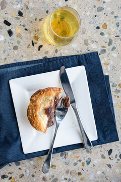 halfway through a meat pie, and beer