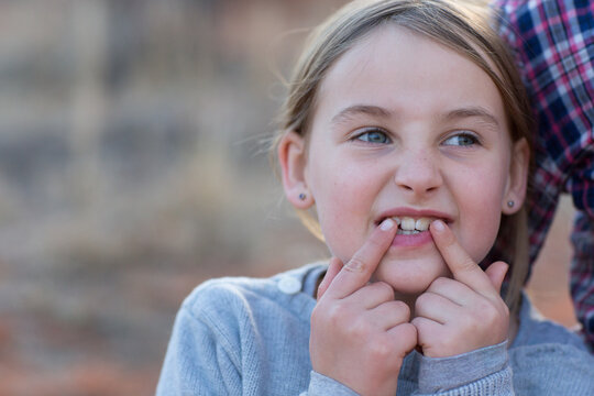 Child pointing to two front teeth