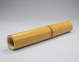 A natural bamboo tube, featuring a smooth, cylindrical shape with one end neatly cut open, showcasing its hollow interior and textured surface.