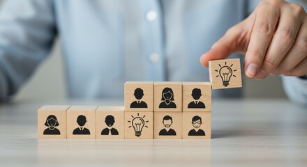 Person adding lightbulb block to team blocks representing ideas and collaboration.