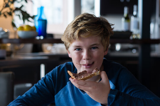 tween boy enjoying toast for breakfast