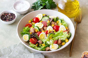 Salad with tuna, eggs, tomatoes, cucumbers and corn. Healthy eating. Diet.