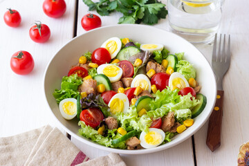Salad with tuna, eggs, tomatoes, cucumbers and corn. Healthy eating. Diet.