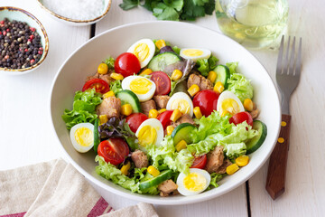 Salad with tuna, eggs, tomatoes, cucumbers and corn. Healthy eating. Diet.