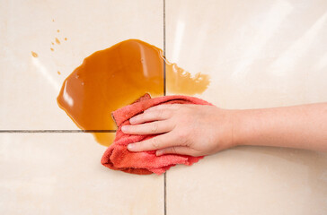 Spilled coffee, coffe puddle stain on tiled floor, messy leak with fallen cup, brown drink spillage