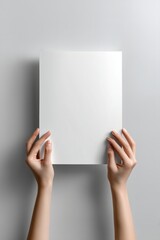 poster mockup featuring a blank white vertical sheet held up by two hands against withe background
