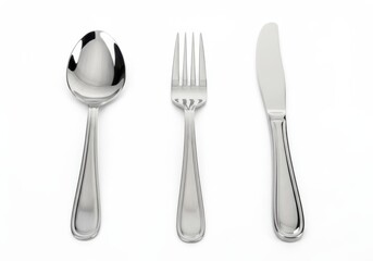 Fototapeta premium Arrangement of cutlery including spoon fork and knife on white surface