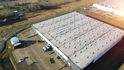 Logistic warehouses surrounded by fields